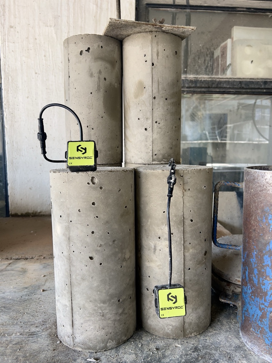Concrete test cylinders with Sensytec sensors for mix-design validation and materials R&D