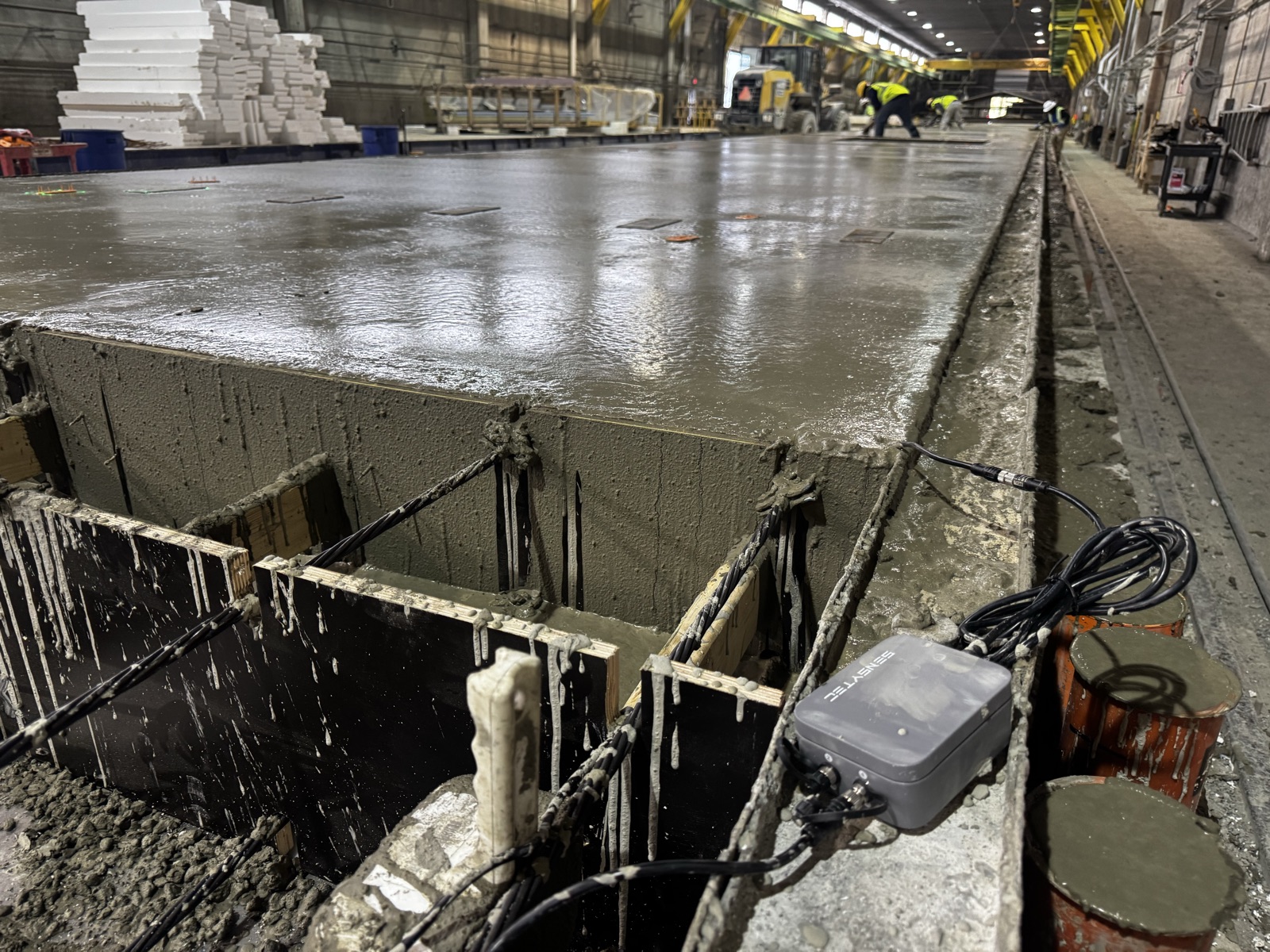 SensyCast sensor deployed on a precast concrete bed during a live pour